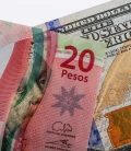 A 20 Mexican peso bill and a 100 US dollar bill.