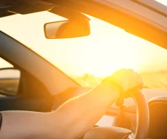 a person driving in a mexican road at sunset