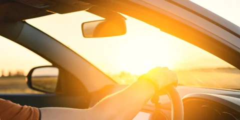 a person driving in a mexican road at sunset