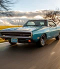 Vintage car driving down a scenic road with clear skies.