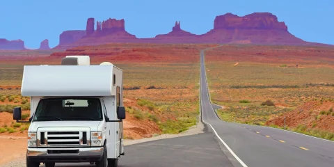 An RV driving on a scenic road