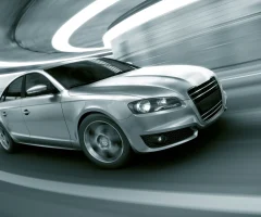 A car speeding through a tunnel, with lights blurring as it accelerates