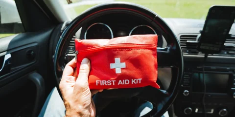 A first aid kit neatly stored inside a car, ready for emergencies.