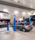 A car in a repair shop, getting ready to be fixed after a breakdown or damage