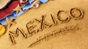 The word 'Mexico' beautifully written in the sand on a beach