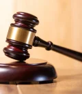 Close-up of a judge's gavel on the bench in a courtroom