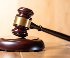 Close-up of a judge's gavel on the bench in a courtroom