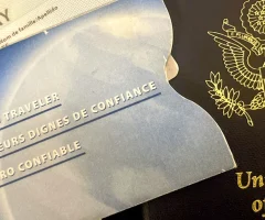 a closeup of an USA passport with a Sentri document in the side