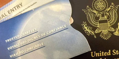 a closeup of an USA passport with a Sentri document in the side