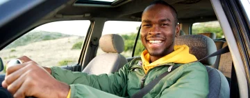 A person sitting in a car, ready to start their journey to Mexico