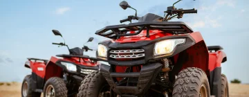 Two quad bikes in a dirt road