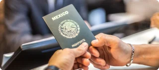 A close-up of a Mexican passport being held in someone's hand, showcasing the official identification document.