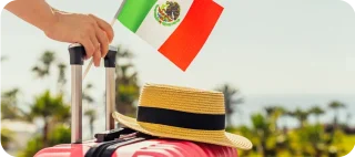 A photo of a suitcase with a person holding a Mexican flag