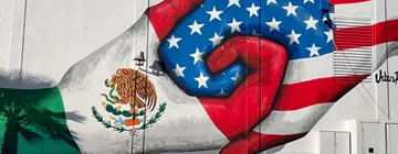 Mural of a mexican and usa flag intertwined